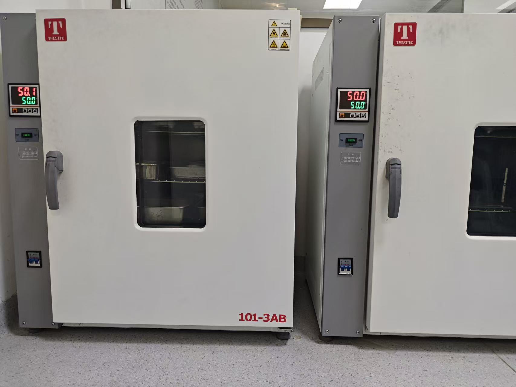 Laboratory equipment with temperature displays and glass viewing windows